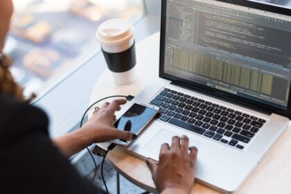 black and silver laptop computer on round brown wooden table 1181243