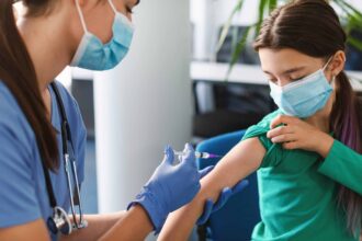 teen girl receiving vaccine injection in arm in me 2021 10 20 00 22 34 utc scaled 1