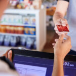 cashier accepts card payment from customer