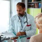 worried doctor talking with a woman patient shutterstock 2538651705