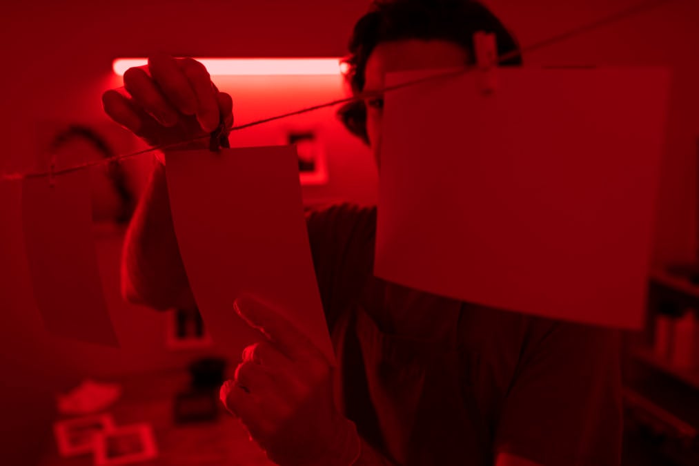 side view man developing photos 1013x675 1