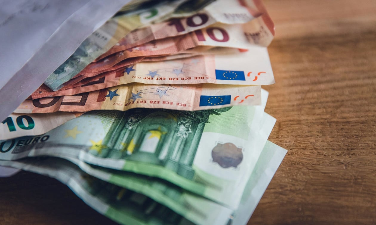Ευρωχαρτονομίσματα δίπλα σε υπολογιστή για θέμα επιστροφής φόρου